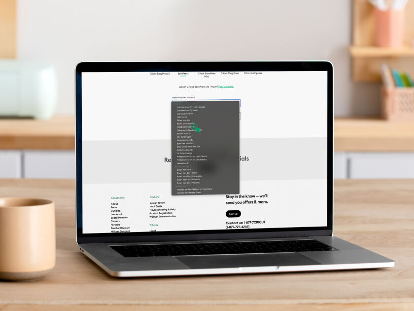 Woman's hand holding a smart phone with a personalized project template pulled up using Cricut's Design Space app